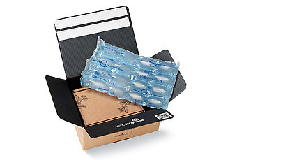 
			Open cardboard box with protective air cushions
